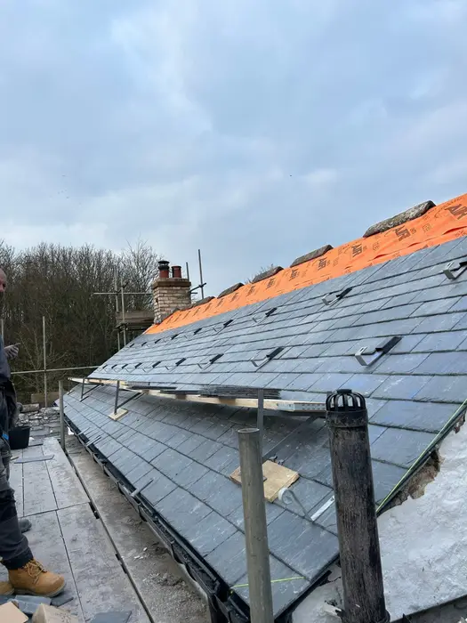 Slates being laid on a roof