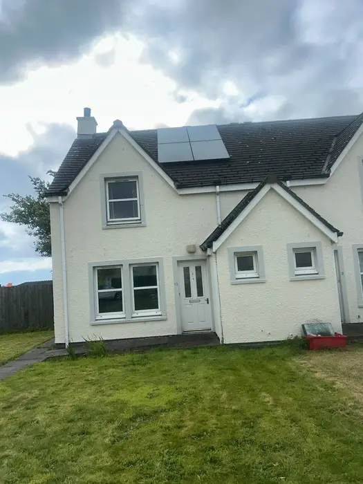Black solar panels on the roof of a house
