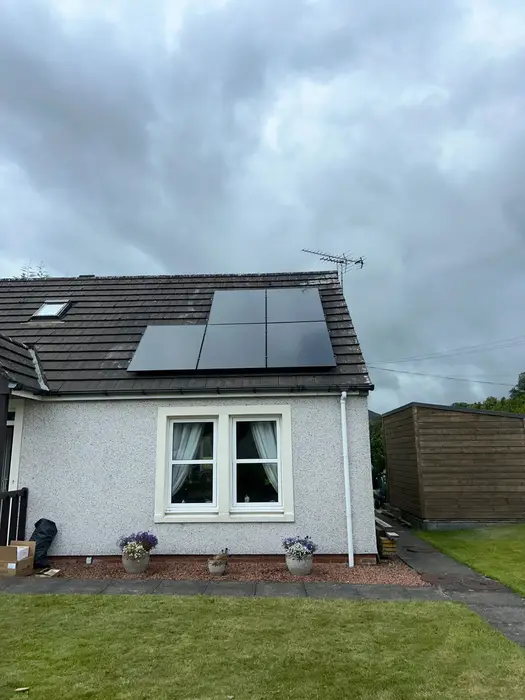 Black solar panels on the roof of a house