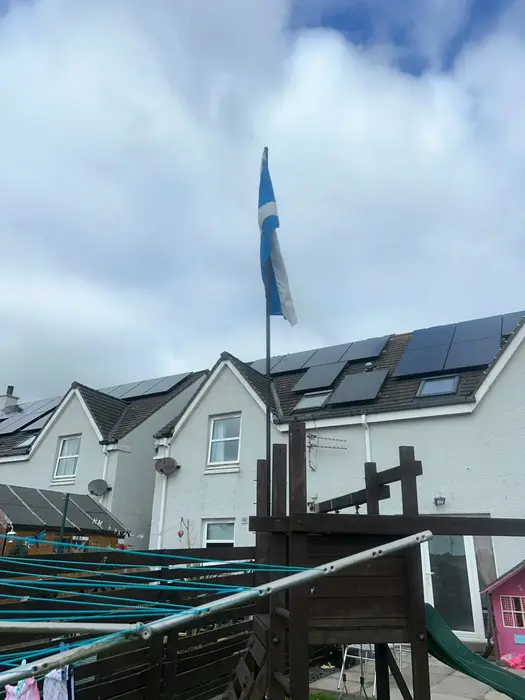 Black solar panels on the roofs of modern homes